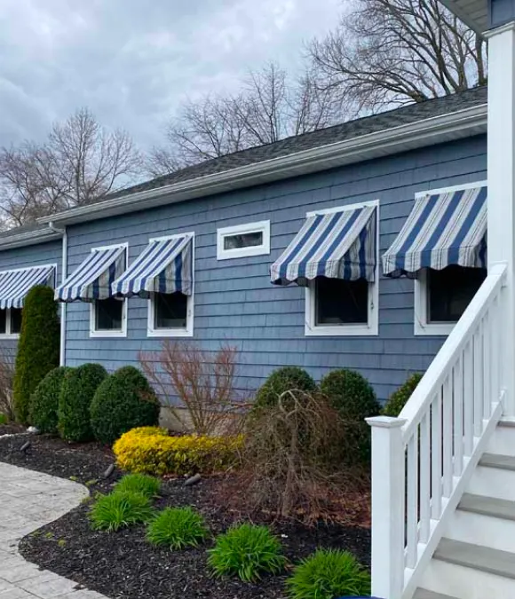 Blue-white striped awning installed in home in Eatontown, NJ